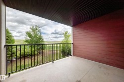 Private balcony with a concrete floor and black metal railings - 