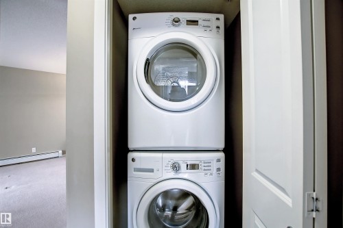 Dedicated laundry closet with stacked washer and dryer unit - 215 1510 Watt Drive, Edmonton, AB 