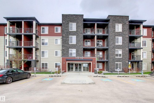Contemporary multi-story building featuring a red, beige, and dark stone exterior - 215 1510 Watt Drive, Edmonton, AB 