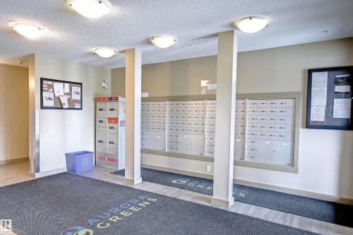 Lobby area featuring wall-mounted mailboxes and parcel lockers - 215 1510 Watt Drive, Edmonton, AB 