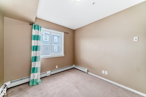 Bedroom featuring a single window, neutral wall paint, and gray carpet - 215 1510 Watt Drive, Edmonton, AB 