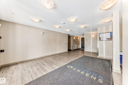 Foyer area featuring wood-finish flooring, neutral wall tones, and recessed ceiling lighting - 215 1510 Watt Drive, Edmonton, AB 