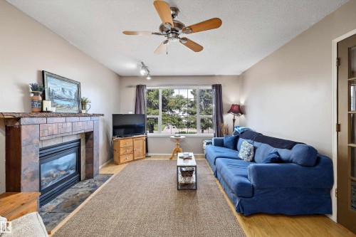 18 Harmony Crescent, Stony Plain, AB - Indoor Photo Showing Living Room With Fireplace