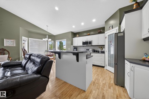 Kitchen featuring white cabinetry, dark countertops, and stainless steel appliances - 4113 59 Street, Beaumont, AB 