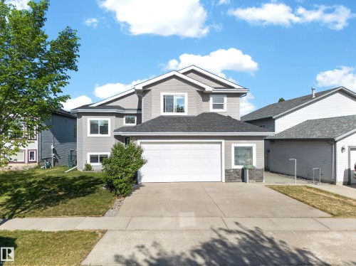 Contemporary two-story residence featuring light gray siding and a dark shingled roof - 4113 59 Street, Beaumont, AB 