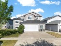 Contemporary two-story residence featuring light gray siding and a dark shingled roof - 4113 59 Street, Beaumont, AB 