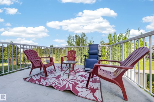 Concrete patio with white railing - 4113 59 Street, Beaumont, AB 