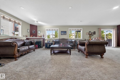 Spacious room featuring carpeting and multiple windows - 4113 59 Street, Beaumont, AB 