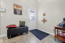 Entryway featuring a white door with decorative glass, light-toned wall paint, and tiled flooring - 4113 59 Street, Beaumont, AB 