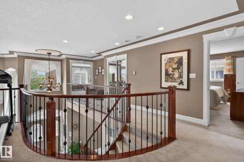 Foyer with arched double entry doors featuring decorative glass inserts and an arched transom window - 1508 Palmer Close, Edmonton, AB 