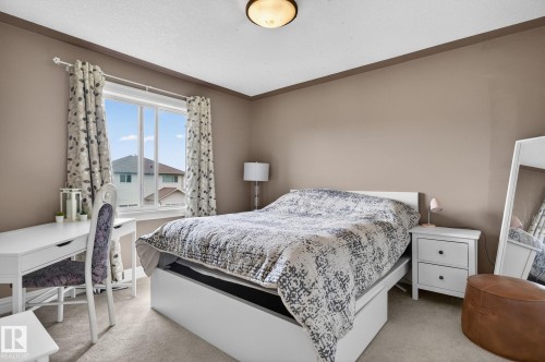 Living area featuring an arched doorway with decorative columns, recessed lighting, and a prominent built-in media center with shelving - 1508 Palmer Close, Edmonton, AB 