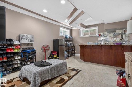 Open-concept living space featuring an arched doorway and tray ceiling with recessed lighting - 1508 Palmer Close, Edmonton, AB 