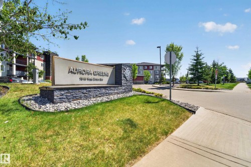 Stone-clad monument sign with "Aurora Greens" text and address - 225 1510 Watt Drive, Edmonton, AB - Outdoor With View