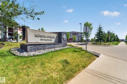 Stone-clad monument sign with "Aurora Greens" text and address - 