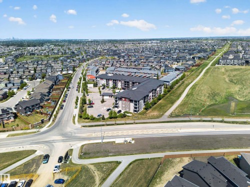 Aerial landscape showcasing a multi-story residential building with private balconies - 225 1510 Watt Drive, Edmonton, AB - Outdoor With View