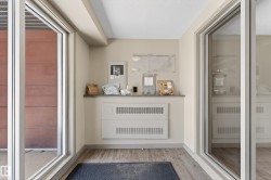 Entry area featuring wood-finish flooring, light neutral wall paint, and a built-in counter - 