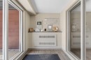 Entry area featuring wood-finish flooring, light neutral wall paint, and a built-in counter - 225 1510 Watt Drive, Edmonton, AB  - Indoor Photo Showing Other Room 