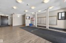 Building entryway featuring wood-finish flooring, recessed lighting, and a mailroom area with individual mailboxes - 225 1510 Watt Drive, Edmonton, AB  - Indoor Photo Showing Other Room 
