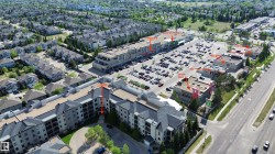 Aerial perspective showcasing the multi-story residential building and surrounding commercial properties - 