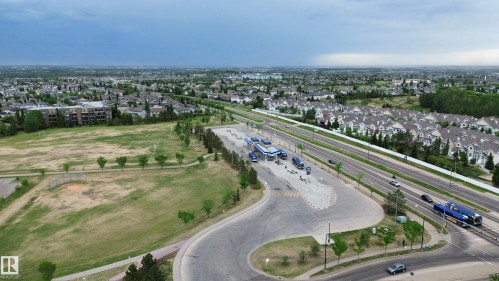 Aerial perspective showcasing a residential area with extensive green spaces - 117 160 Magrath Road, Edmonton, AB - Outdoor With View