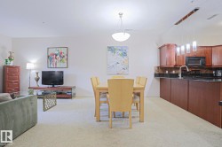 Open-concept living space featuring light-toned carpeting - 