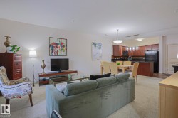 Open-concept living area with carpeting, recessed lighting, and a chandelier - 