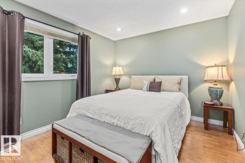 Bedroom featuring light green walls, recessed lighting, and wood-finish flooring - 6720 29 Avenue, Edmonton, AB 