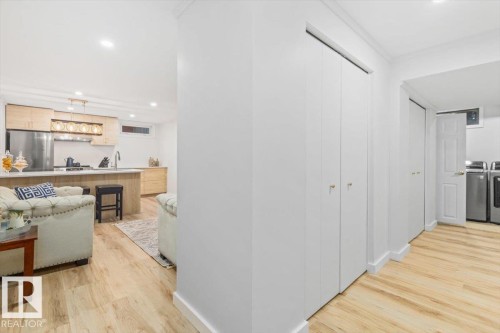 Light wood-finish flooring extending through the space - 6720 29 Avenue, Edmonton, AB 