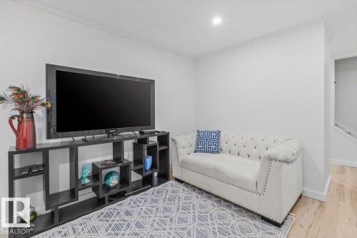 White walls with crown molding, recessed lighting, and wood-finish flooring - 6720 29 Avenue, Edmonton, AB 