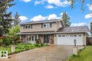 Two-story residence featuring light-colored siding and a bay window - 6720 29 Avenue, Edmonton, AB 