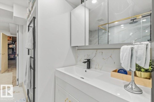 Contemporary vanity featuring a white rectangular sink with a matte black faucet, integrated storage, and a mirrored medicine cabinet - 6720 29 Avenue, Edmonton, AB 