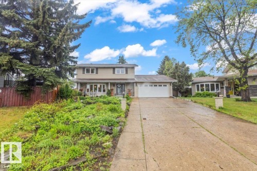 Two-story residence featuring light-toned siding and dark window shutters - 6720 29 Avenue, Edmonton, AB 
