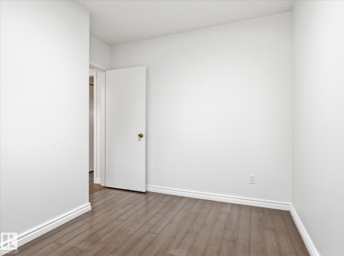 Room featuring light wood-finish flooring, white walls, and white baseboards - 13316 136 Avenue, Edmonton, AB 