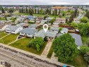 Single-story residence featuring a shingle roof, established front yard landscaping, and a paved driveway - 13316 136 Avenue, Edmonton, AB 