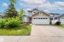 Front exterior with beige siding and white trim - 16811 91 Street, Edmonton, AB 