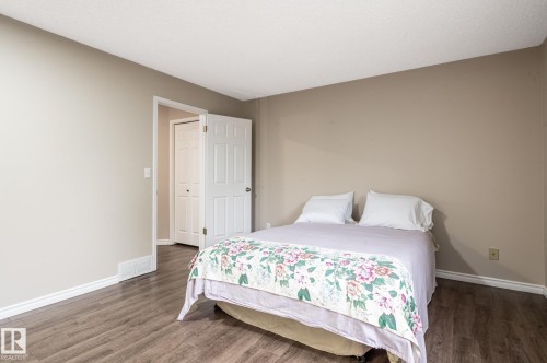 Neutral-toned walls complement wood-finish flooring in this room - 16811 91 Street, Edmonton, AB 