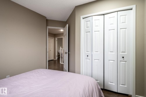 White bi-fold closet doors with black knobs - 16811 91 Street, Edmonton, AB 