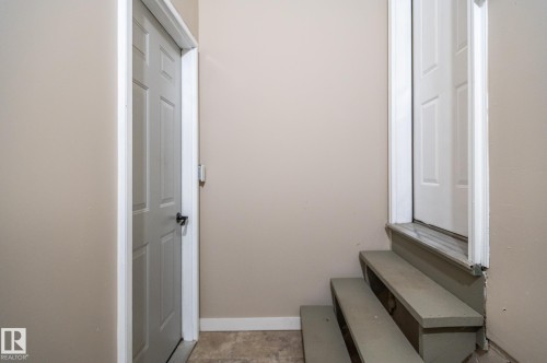 Interior doorway with a six-panel door and black hardware - 16811 91 Street, Edmonton, AB 