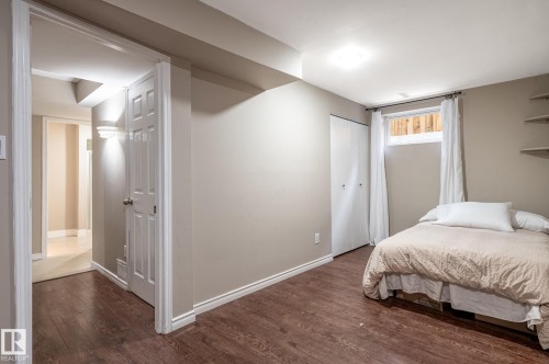 Room featuring wood-finish flooring, neutral wall paint, and white trim - 16811 91 Street, Edmonton, AB 