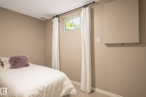 Compact room featuring light beige wall paint, white trim, and light-colored carpeting - 16811 91 Street, Edmonton, AB 