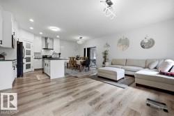 Open concept living space featuring wood-finish flooring - 