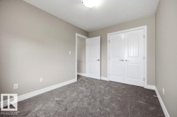 Neutral-toned walls complement plush grey carpeting - 