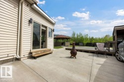 Expansive concrete patio with direct access to interior spaces via sliding glass doors - 