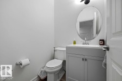 Powder room featuring a single vanity with a white countertop and base cabinetry - 