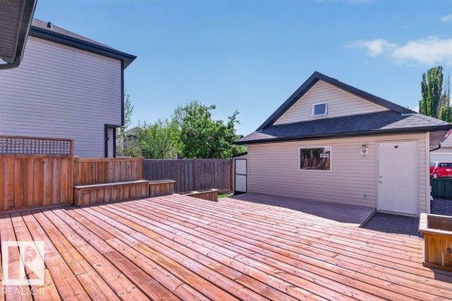 Expansive outdoor wood deck with built-in seating and planters - 12215 18 Avenue Sw, Edmonton, AB 