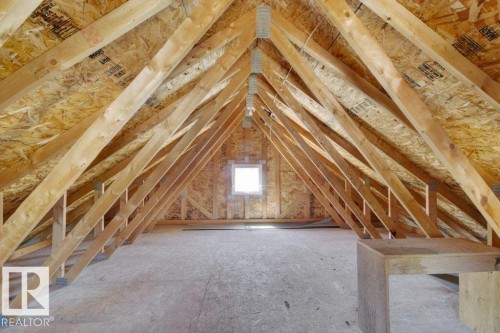 Unfinished attic space featuring exposed wood truss framing and oriented strand board (OSB) sheathing - 12215 18 Avenue Sw, Edmonton, AB 
