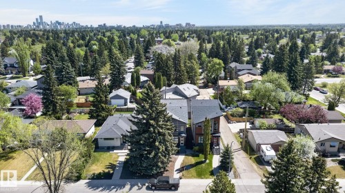 Residential neighborhood featuring mature trees and a distant cityscape - 8809 148 Street, Edmonton, AB - Outdoor With View