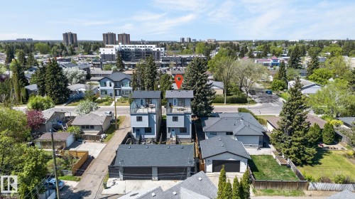 Contemporary residential building featuring light blue siding and dark gray trim - 8809 148 Street, Edmonton, AB - Outdoor With View