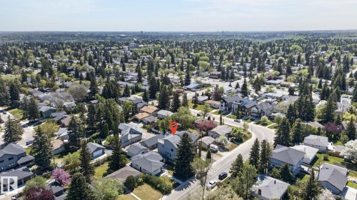 Aerial perspective showcasing a residential area with a prominent subject property - 8809 148 Street, Edmonton, AB - Outdoor With View