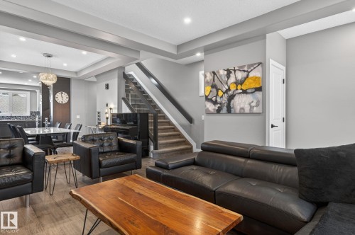 Open-concept living area with tray ceiling detail and recessed lighting - 8809 148 Street, Edmonton, AB - Indoor Photo Showing Living Room